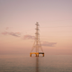 Power lines and a tower sitting in the middle of water near Kenner, Louisiana.